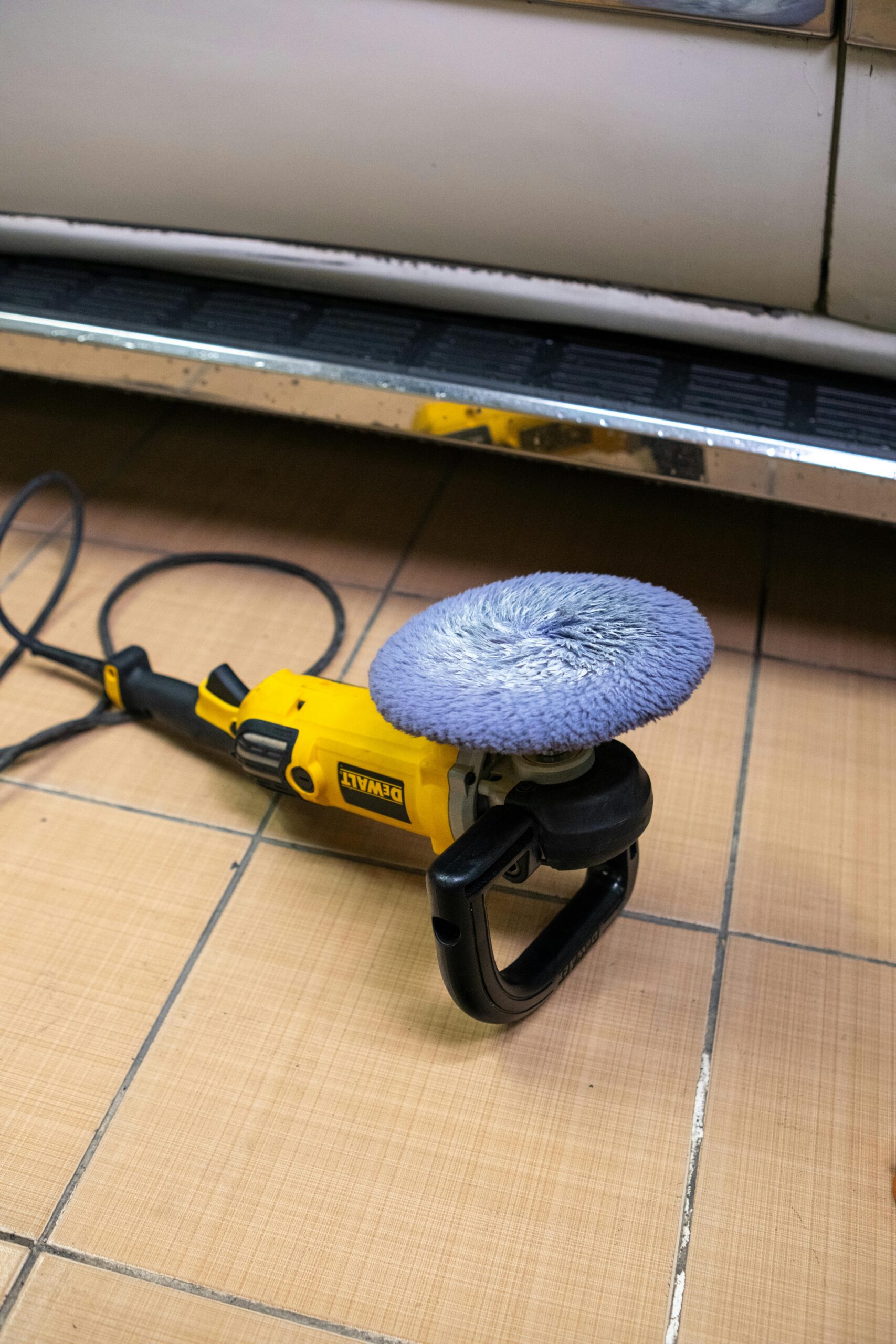 3:30 AMClaude responded: DeWalt rotary car polisher with microfiber buffing pad on garage floor ready for car paint correction and detailingDeWalt rotary car polisher with microfiber buffing pad on garage floor ready for car paint correction and detailing