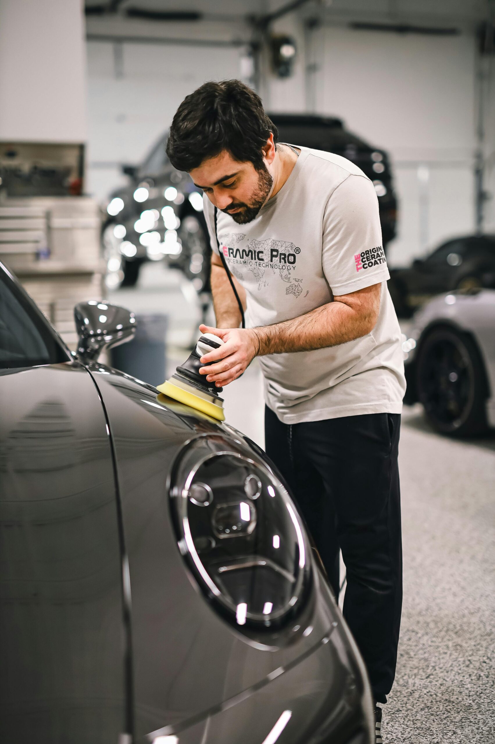 3:25 AMClaude responded: Professional car detailer using a dual action polisher on a Porsche in a professional auto detailing garageProfessional car detailer using a dual action polisher on a Porsche in a professional auto detailing garage